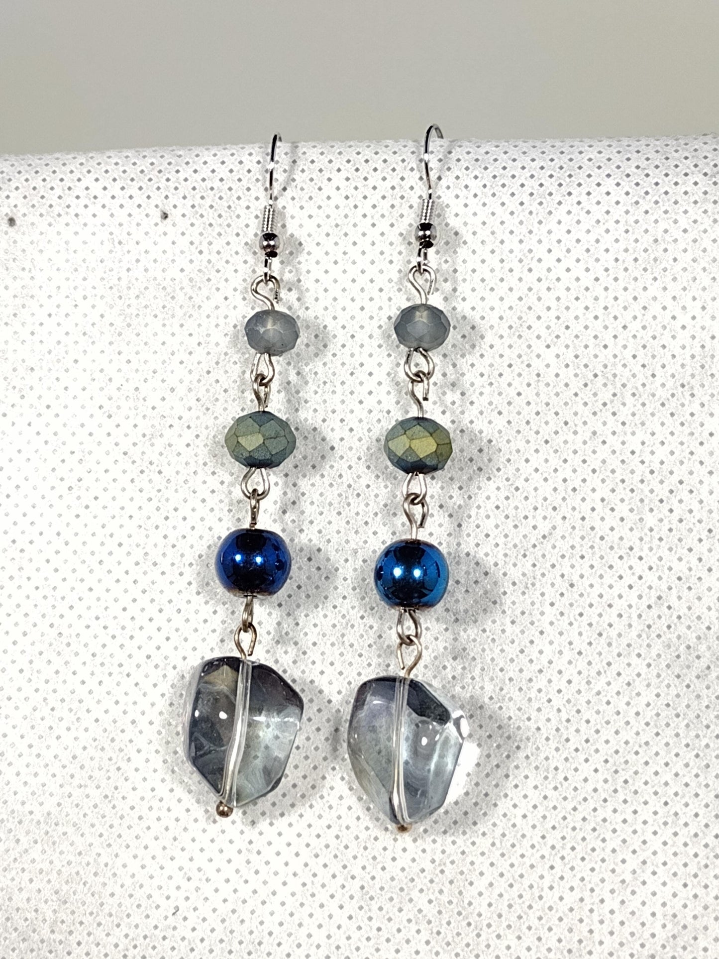 Iridescent blue acrylic beads linked with smaller blue glass beads