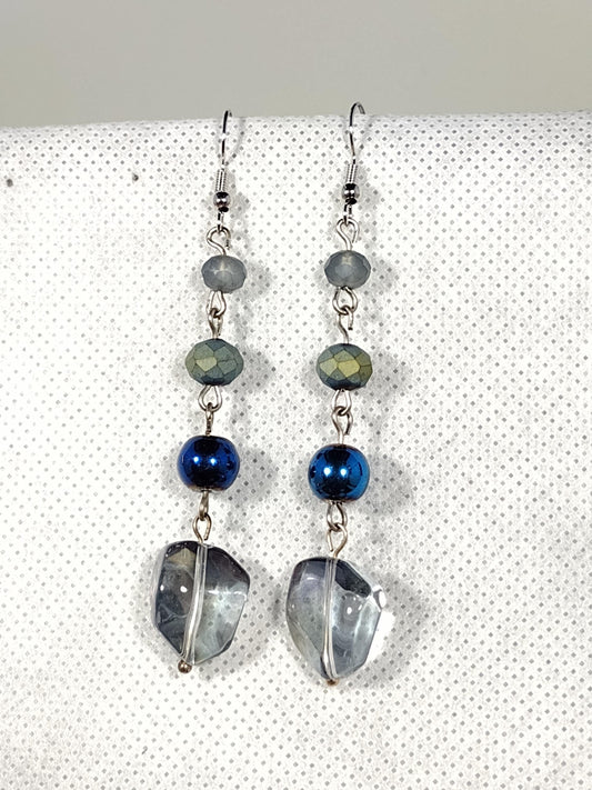 Iridescent blue acrylic beads linked with smaller blue glass beads
