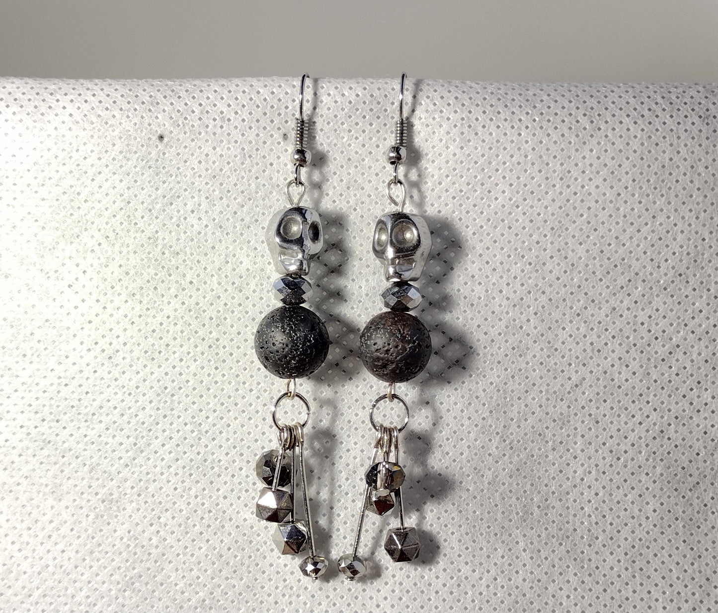 Silver skull dangle earrings with black lava rock beads