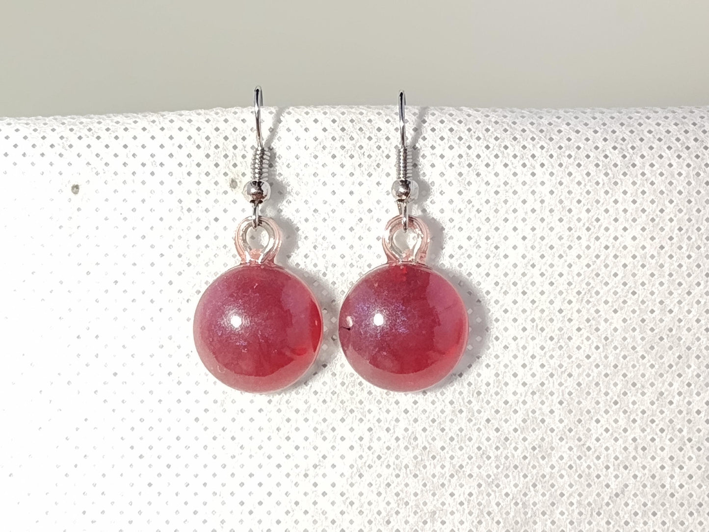 Round dark red resin earrings with blue shimmer shift
