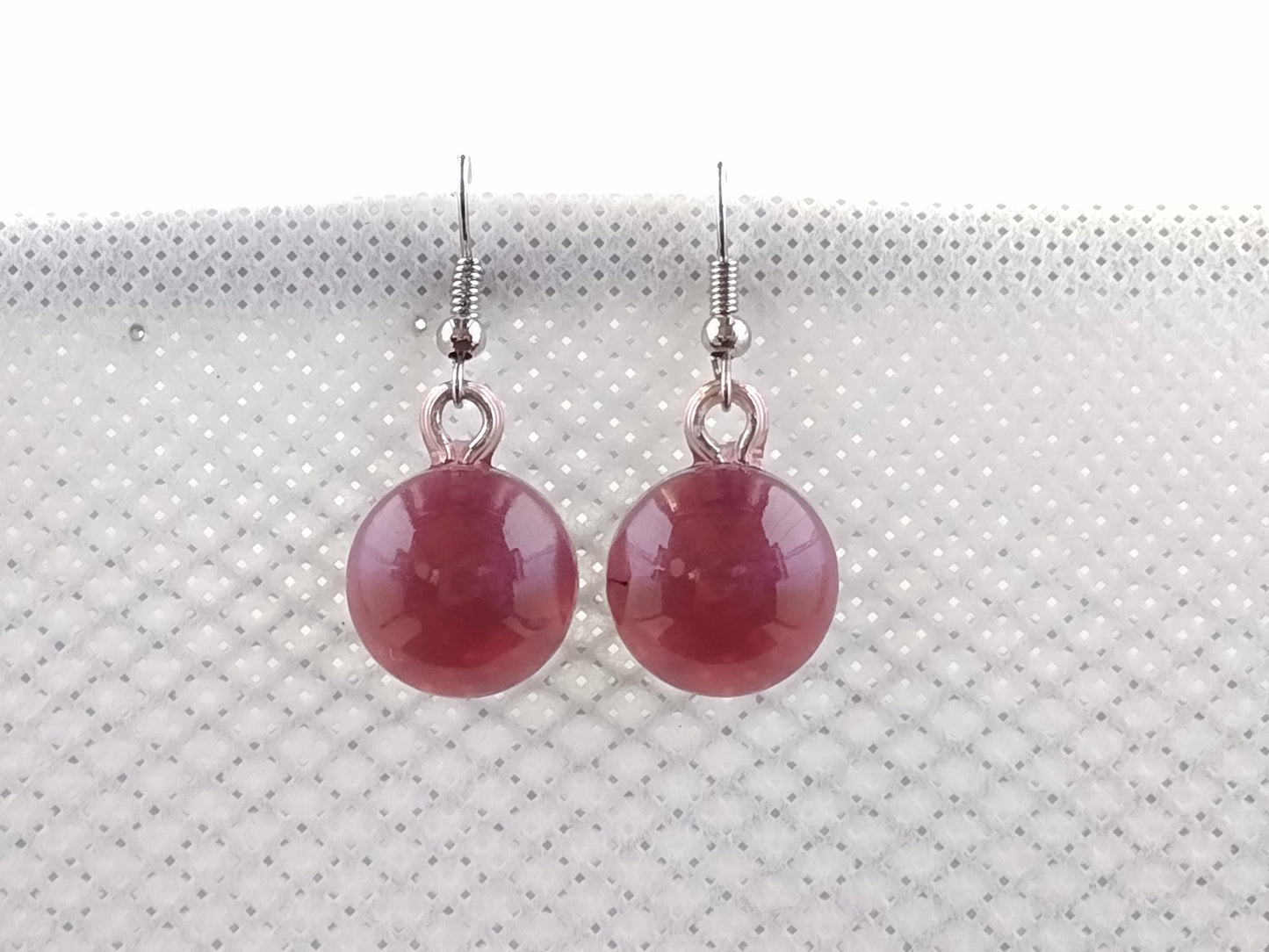 Round dark red resin earrings with blue shimmer shift
