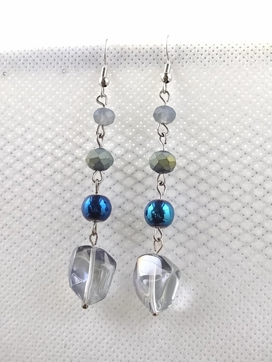 Iridescent blue acrylic beads linked with smaller blue glass beads